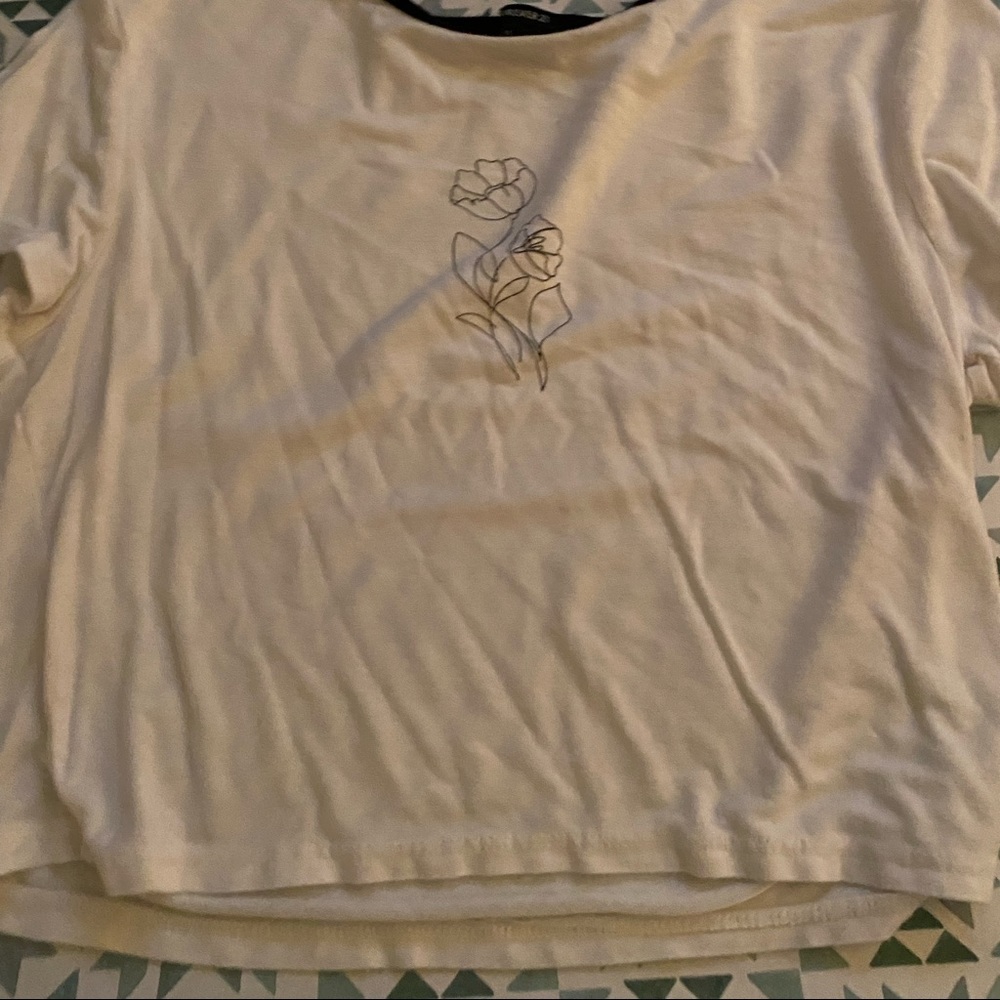 white t shirt with simple cute flower in front. cropped and easy to style